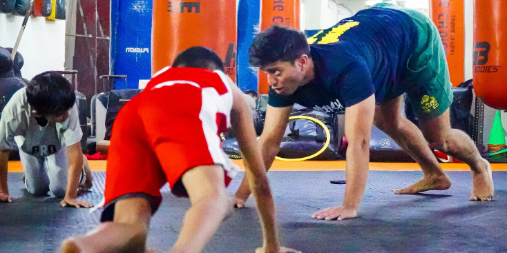 an adult and children are on their hand and feet doing fun exercises together