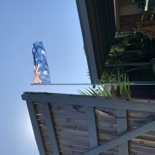 A flag flies in front of a wooden door