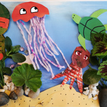 A child's underwater themed collage with a red jellyfish