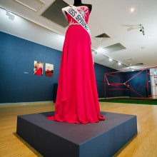 Artefacts from Anastasia Klose’s performance Miss Spring 1883 (2016). A dress, bespoke sash and two documentation photos in the background. Photography: EP Group Australia