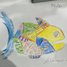 A child's drawing of a multi-coloured fish