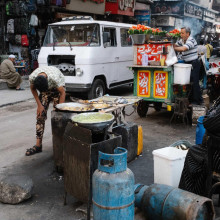 Van zooming past street vendors by Brandon Kim