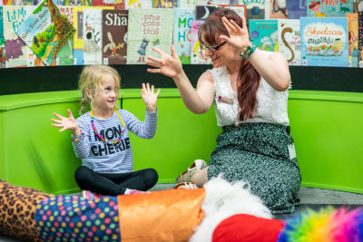 A white child and a white woman waving their hands