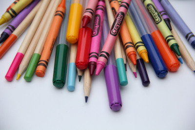 coloured pencils and crayons on a white background