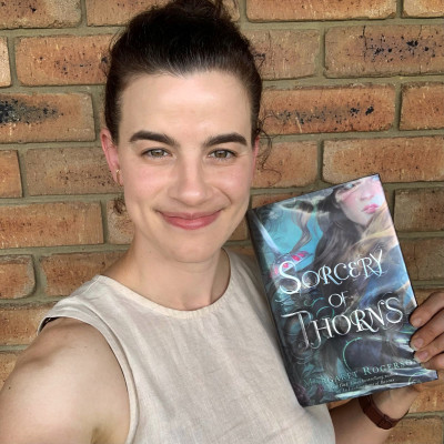Sophie holds a copy of the novel Sorcery of Thornes