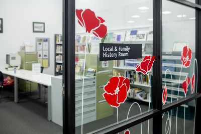 A view through glass walls of the Family History room.