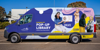 the library programs van. It's a large van painted with pictures of people reading and the text "pop-up library"