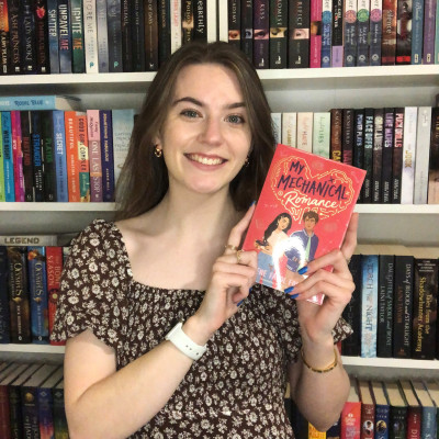 Librarian Caitlin holds a copy of My Mechanical Romance