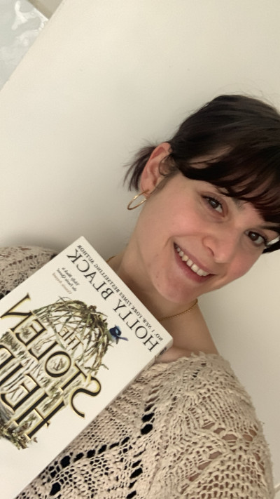 Librarian Alisha holds a copy of the Stolen Heir