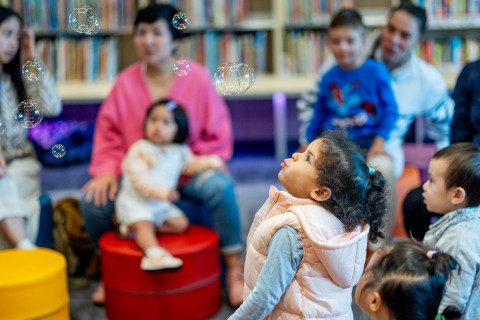 Small children with bubbles in the library