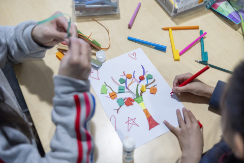 Overhead view of children completing a craft activity at the library.