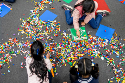 Children building with Lego bricks.
