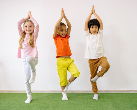 three kids doing yoga