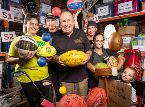 a group of people are holding up sport equipment and smiling at the camera