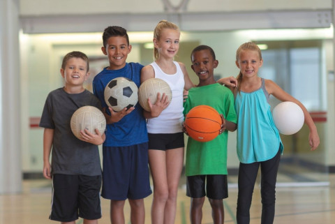 Kids holding sports balls