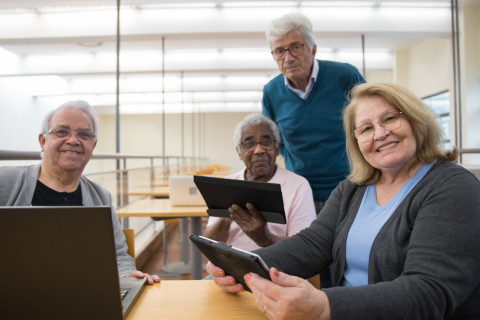 A group of seniors looking at tablets