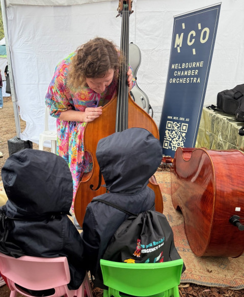 Musician playing double bass for children