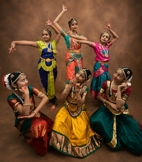 Indian classical Bharatanatyam dancers performing in vibrant traditional attire