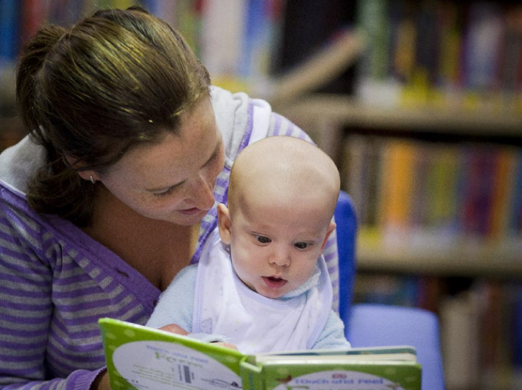 Mum and baby reading a book 