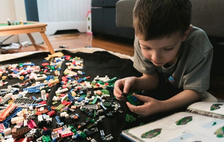 Young boy playing with LEGO