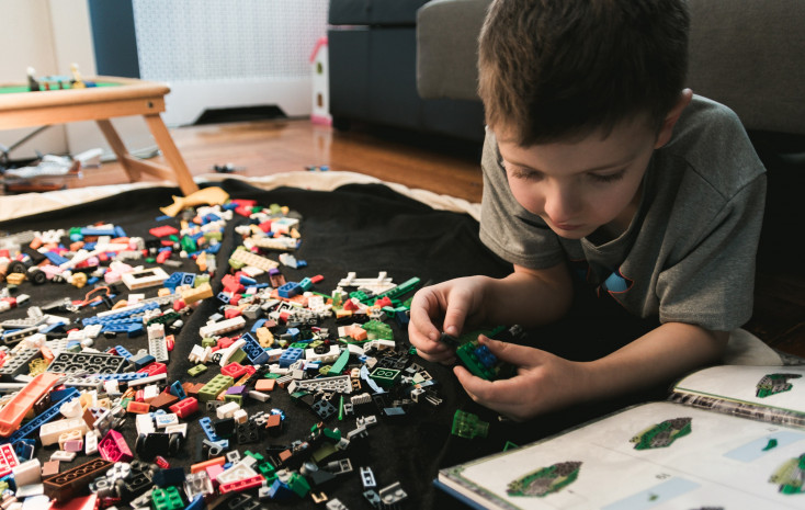 Child building and playing with lego
