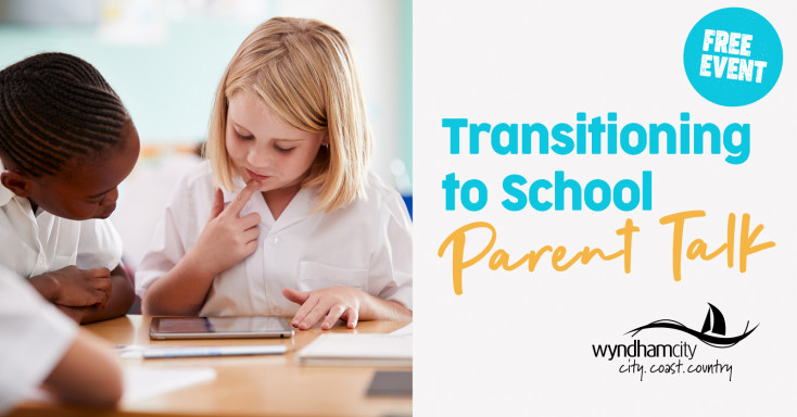2 children looking at school work