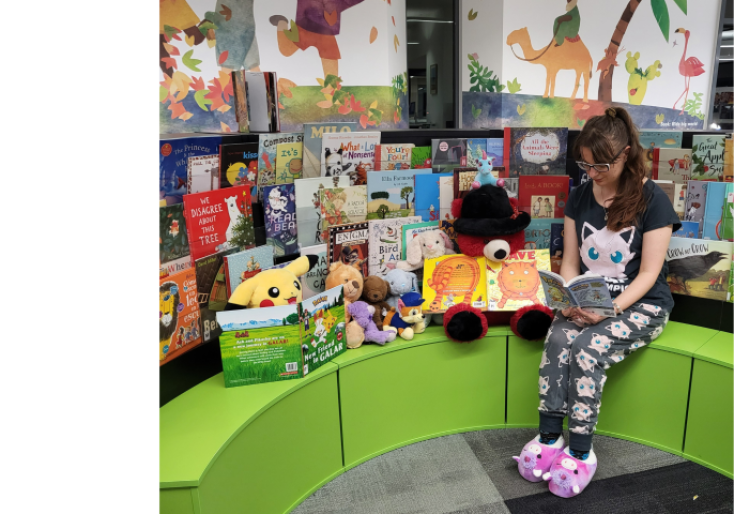 Staff member reading to teddy