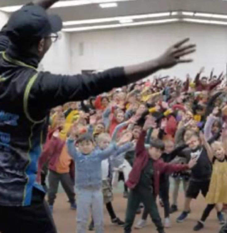 Children being instructed to dance