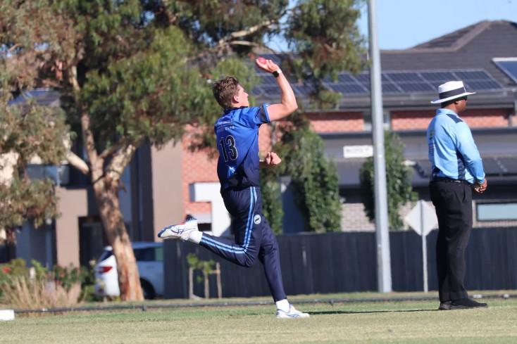 a Teen boys is bowling a cricket ball