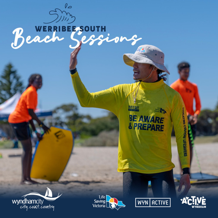 a man in a yellow top and white hat on the beach is waving, people in the background are wearing orange tops and have boogie boards 