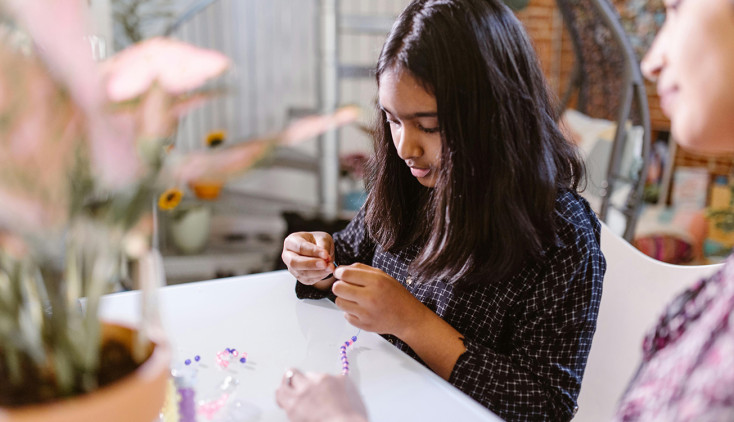 Child making a friendship bracelet