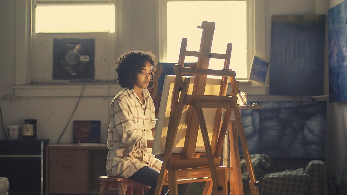 a young person with an easel