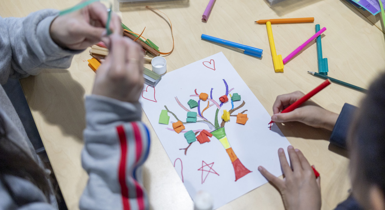 Overhead view of children completing a craft activity at the library.
