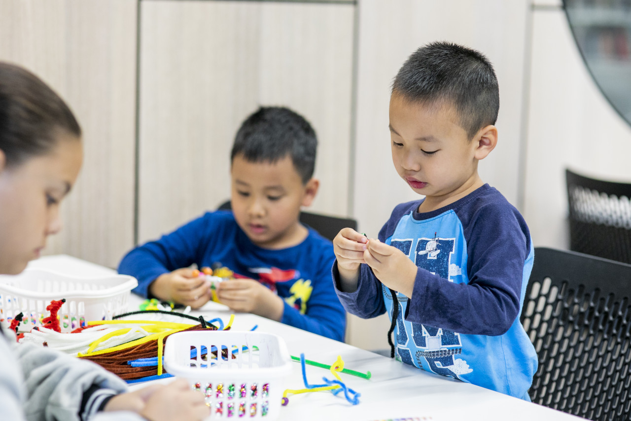 Small children crafting in a library