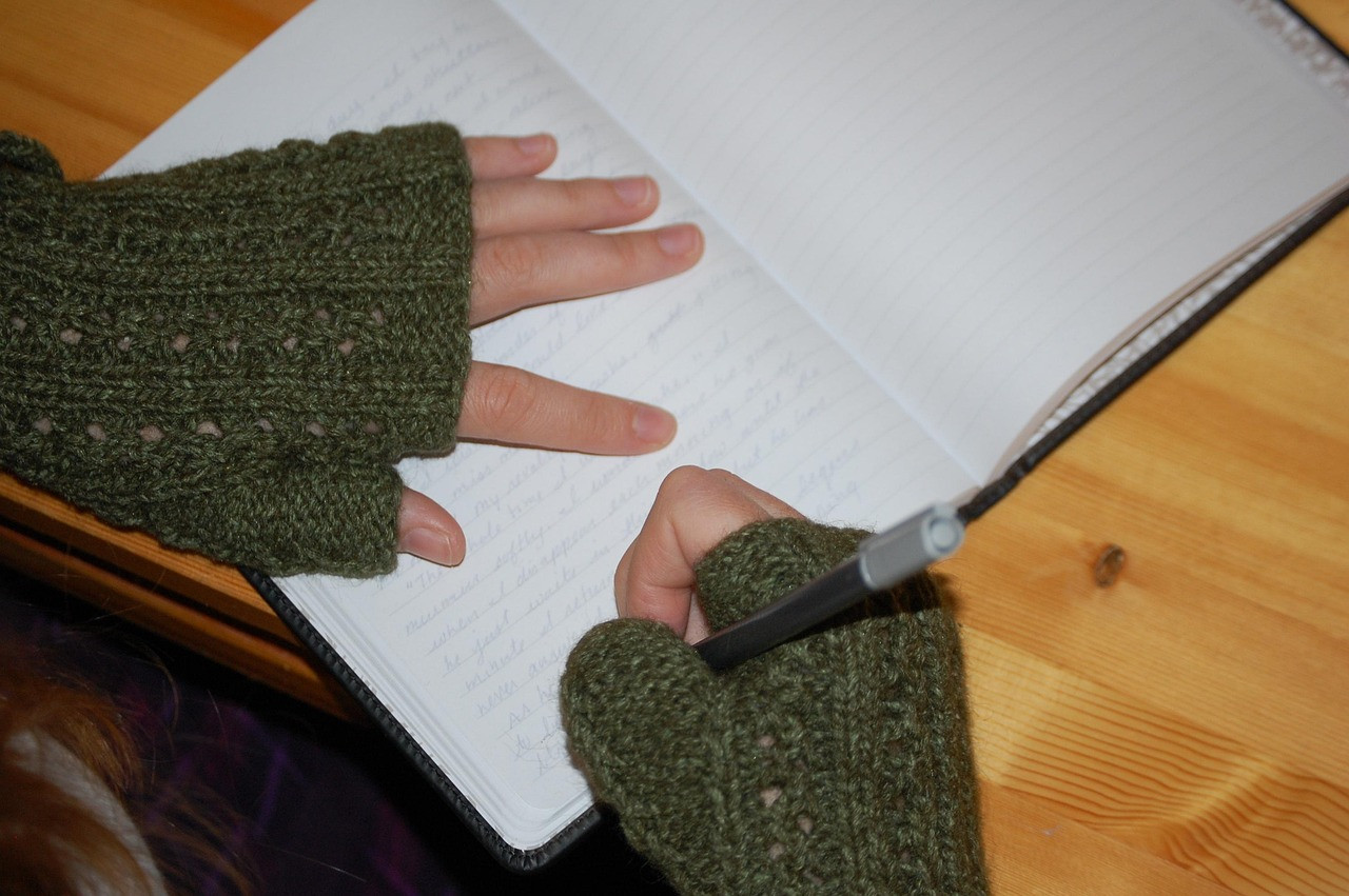 a close up shot of someone in gloves with a pen and paper