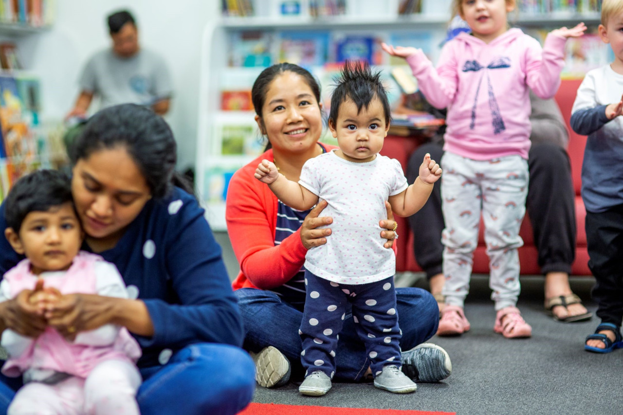 group of parents and children at rhyme time