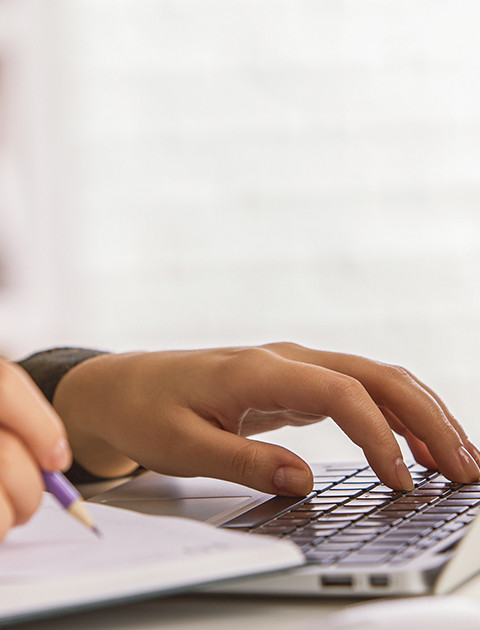 some one sitting in front of a laptop