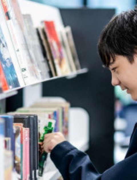 teenager looking at shelves, point cook library