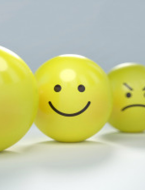 four yellow balls with different facial expressions