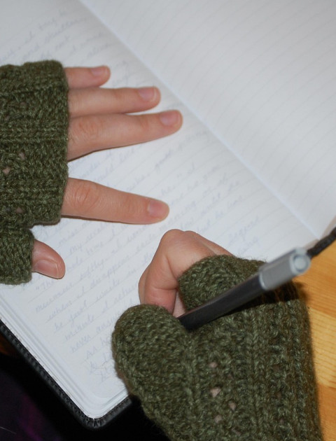 hands in gloves with pen and paper