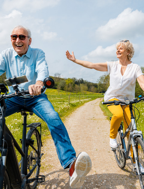 Two older people on bicycles