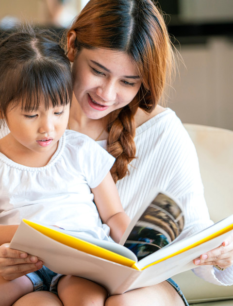 Mother reading to daughter