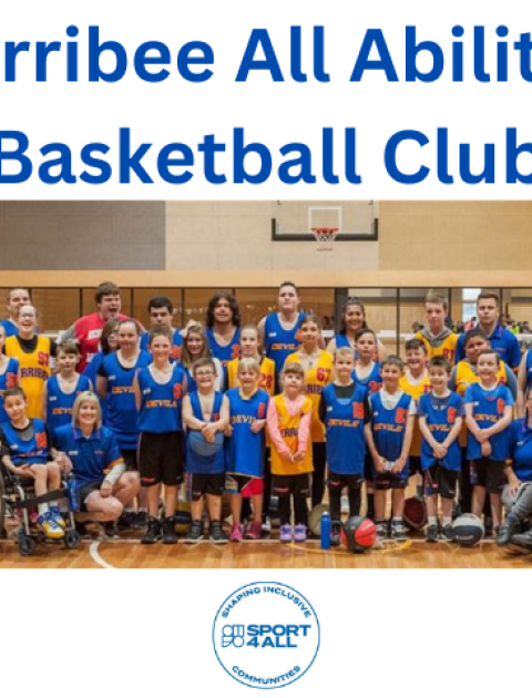 a large group of kids and adults wearing blue basketball kits are smiling at the camera.