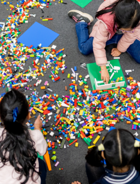 Children building with Lego bricks.