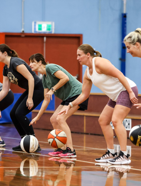 a group of women are bouncing basketballs