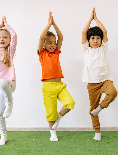 three kids doing yoga