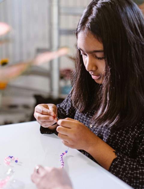 Child making a friendship bracelet