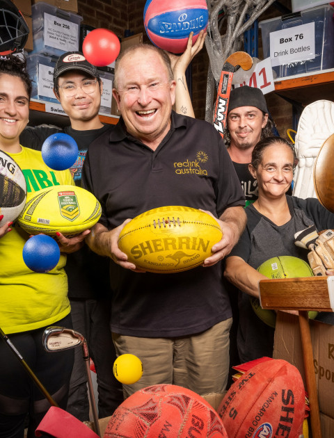 a group of people are holding up sport equipment and smiling at the camera