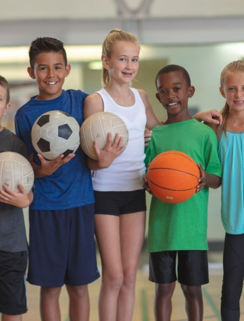 Kids holding sports balls