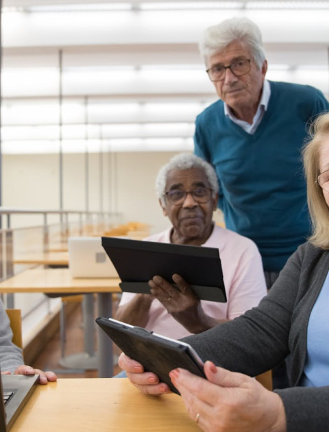 A group of seniors looking at tablets